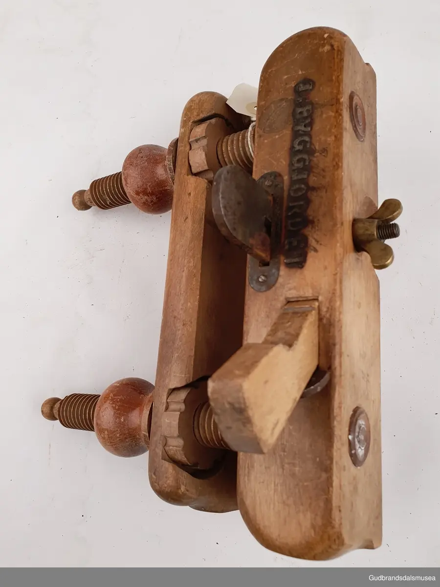 Ploghøvel, stillbar i høyde og bredde. Justeringsskruer i tre. 
Fabrikkprodusert; merket Joh-weiss.
Svimerket; J.m byggjordet, to ulike stempeltyper, 3 ulike plasser på høvelstokken.
Tilhørende 2 ekstra høvelstål. LT-03561, 01 og 02.