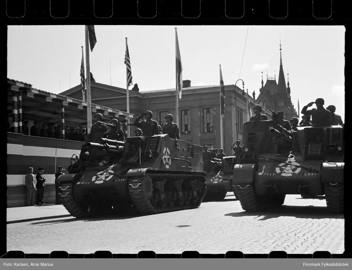 Amerikanske soldater kjører militære kjøretøy som kan ligne på det selvdrevne artilleriet M7 Priest på de alliertes dag den 30. juni 1945 (The Allied Forces day)