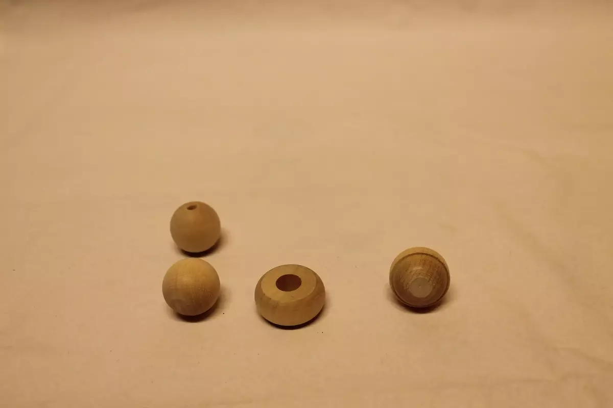 4 ulike knotter:
1. Flat knott, med bora hull på 1 cm i diameter. Ubehandla tre. Ubrukt. 3,4 cm i diameter. 
2. Rund knott med bora hull på 0,5 cm i diameter. Ubehandla tre. Ubrukt. 2,9 cm i diameter
3. Rund knott med bora hull på 0,5 cm i diameter. Ubehandla tre. Ubrukt. 2,9 cm i diameter
4. Konisk forma knott, med dreid bord på midten. Lengde 3,7 cm. Diameter med bord 3 cm. 