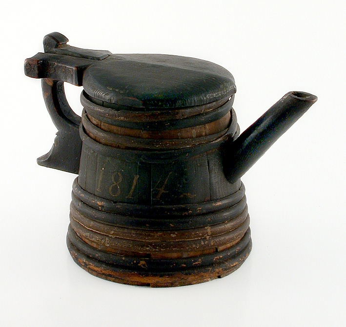 Grönmålat stop med pip, handtag och lock.