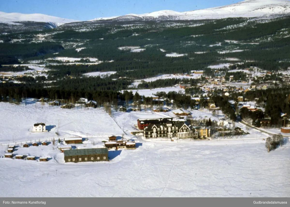 Flyfoto med Dombås Turisthotell, Dombåsgarden og Dombås sentrum.