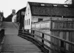 Byggnad f.d. svarvverkstaden vid Nyköpings mekaniska verkstad. 1928 möbelfabrik. Foto från Bembron mot norr, i fonden Nicolai-kyrkans torn. Jfr. foto från 1880-talet.