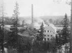 Koppoms pappersbruk sett från öster. Upptill bakom granen synes i bakgrunden Koppoms herrgård. Bostadshuset längst till höger en arbetarbostad.