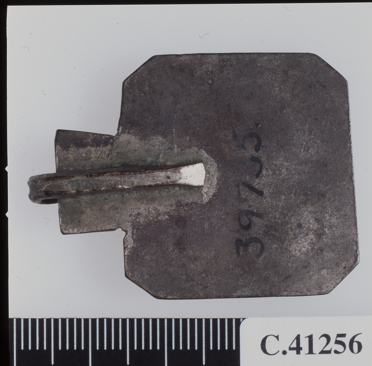 EtnoNo: 39735.
Octogonal collar-sheet with Arabic inscription: "Protector, you protect her who is bearing this sheena (amulet?)". A lug is fastened on its top, obviously for the collar-band.