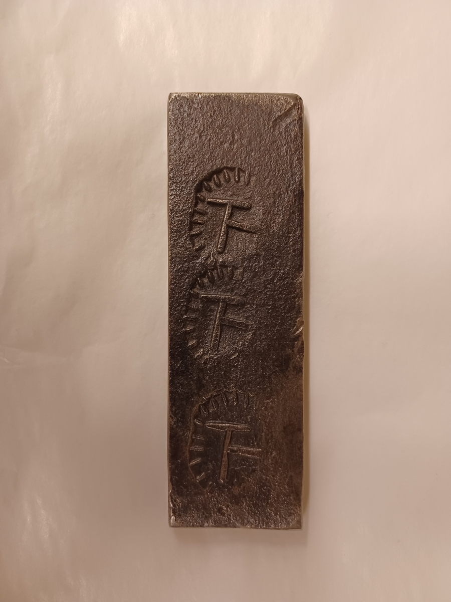 Avtryck av järnstämpel i prov av stångjärn. 