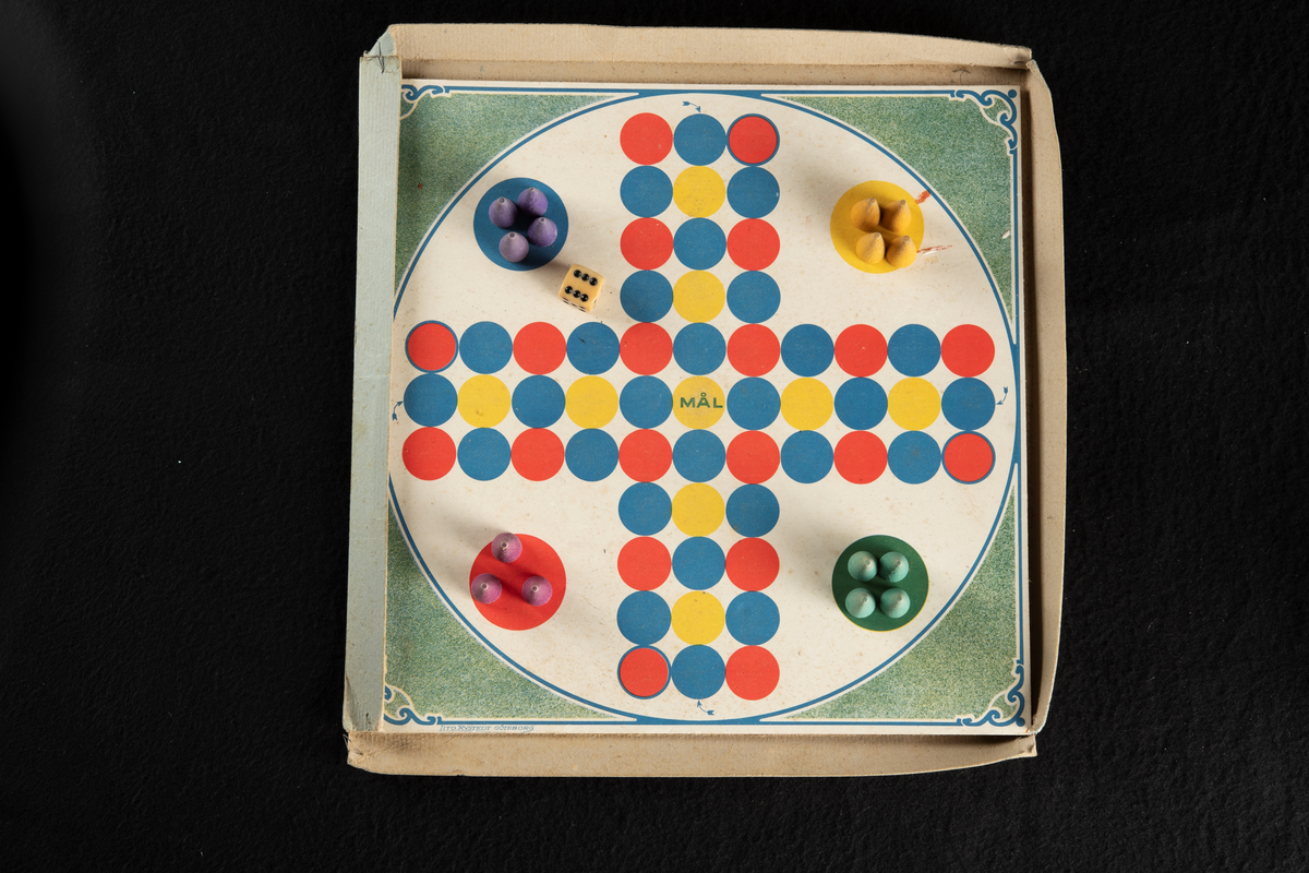 Spel i originalförpackning av papp, med spelplan, instruktioner, tärning och spelpjäser. En spelpjäs saknas. Förpackningen är en kvadratisk, platt ask i ljusgrön, bleknad färg med text på framsidan. Spelplanen är formad som ett kors, bestående av tre rader med prickar för spelpjäsernas placering, i fyra olika färger. I varsitt hörn är spelarnas "bo" markerat, där deltagarna startar, vart och ett i varsin färg; rött, blått, gult och grönt.