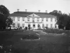 Familj och övriga gäster i samvaro invid huvudbyggnaden till Grensholm. Tillfället rörde godsets ägare, greve Harald Spens 75-årsdag 1902.