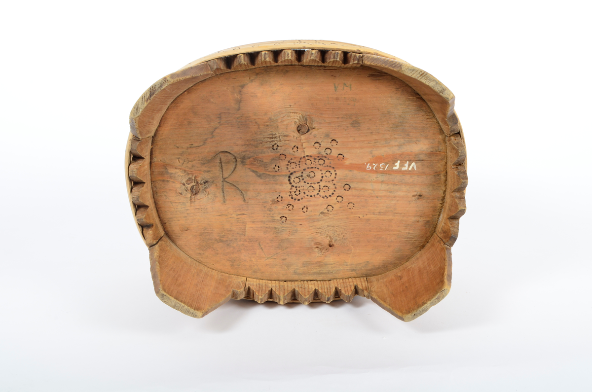 Tre, umalt. Lagget, furu. Ti staver, fire ben. Fire gjorder, to brede og to smale, som sammen dekker stetten ovenfor bena. Kantene mellom bena er takkete. Stetten er oval. Rikt dekorert med svidd ornamentikk. Bare gjordene er dekorert ovenfor bena. Svidd ornamentikk under bunnen.