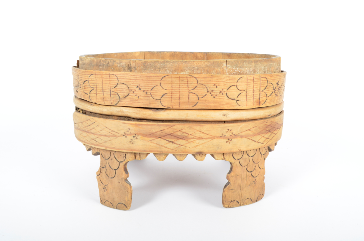 Trekar i furu og bjørk. Lagget, oval form, fire høye ben. To brede gjorder med en vidje i mellom. Sviornamentikk på gjorder og ben.