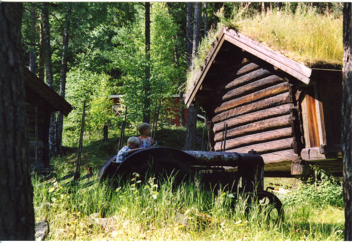 Hallingdal Museum, Nesbyen. Aktivitetsdag på museet. Traktor med to smågutter foran Thoenstugu.

