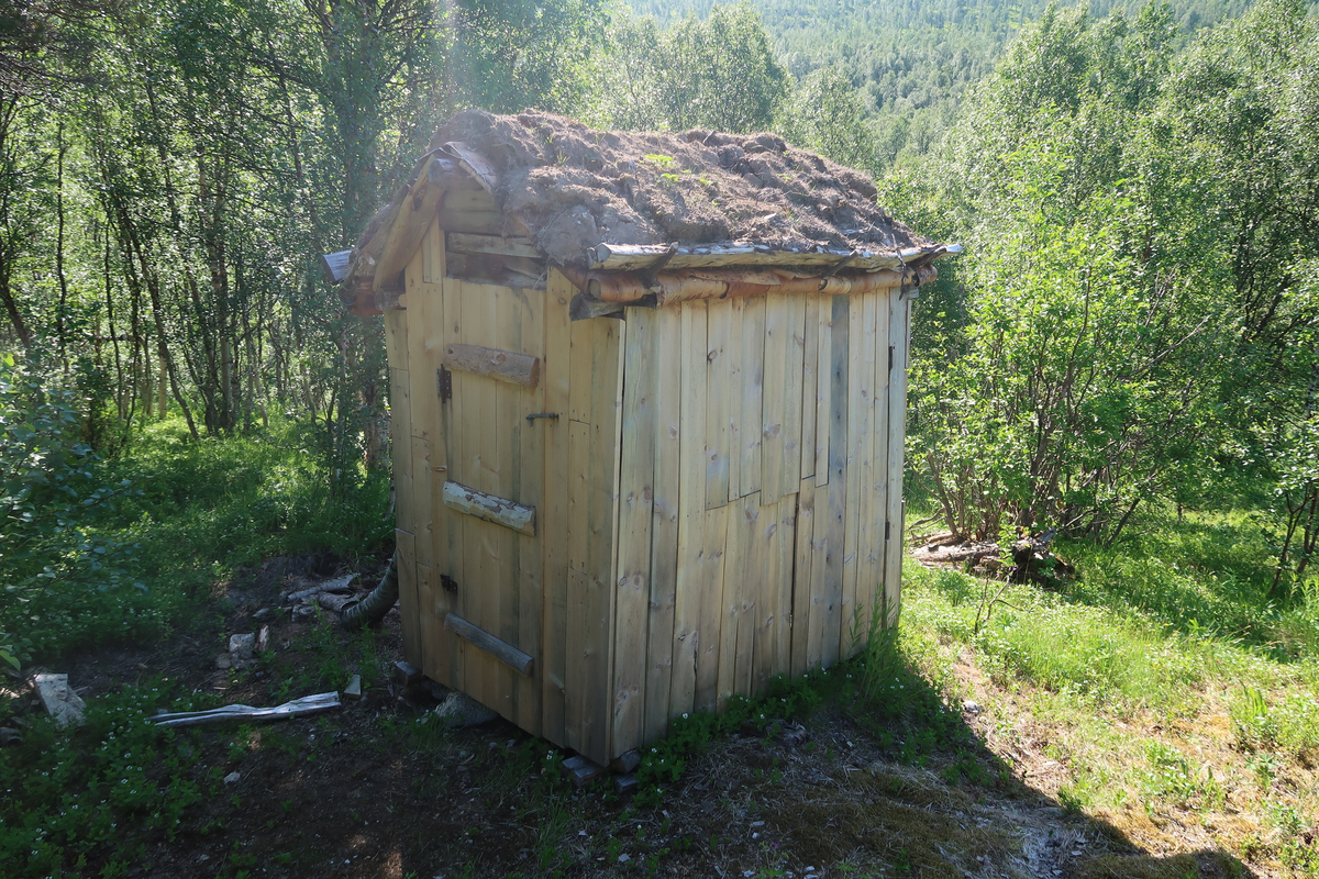 Utedo bygd med materialer tatt ut i Kaperdalen. Bjørk, bjørkenever, einer og torv. Utvendig kledning av kassebord. 