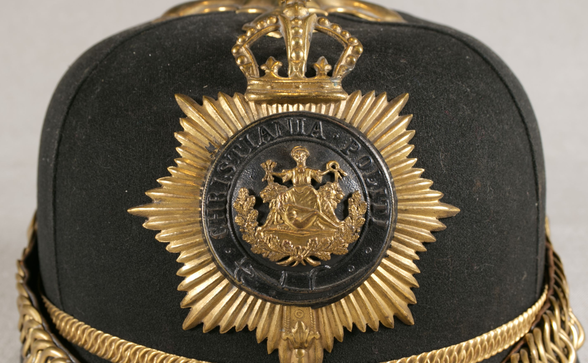 Gullbrokade på ermer og krave.