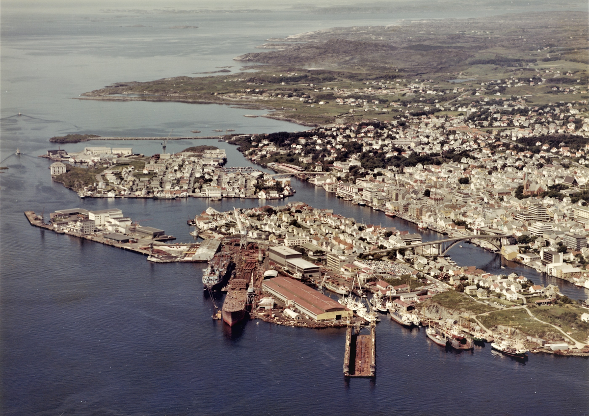 Flyfoto over Risøy, Haugesund og Hasseløy. I forgrunnen ligger Haugesund Mekaniske Verksted (HMV).