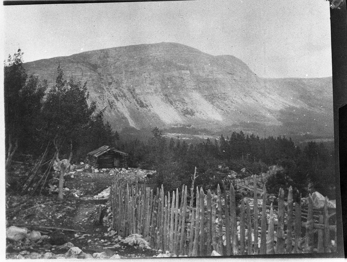 Fjellterreng. Ei gammel seter i forgrunnen. Ukjent sted.