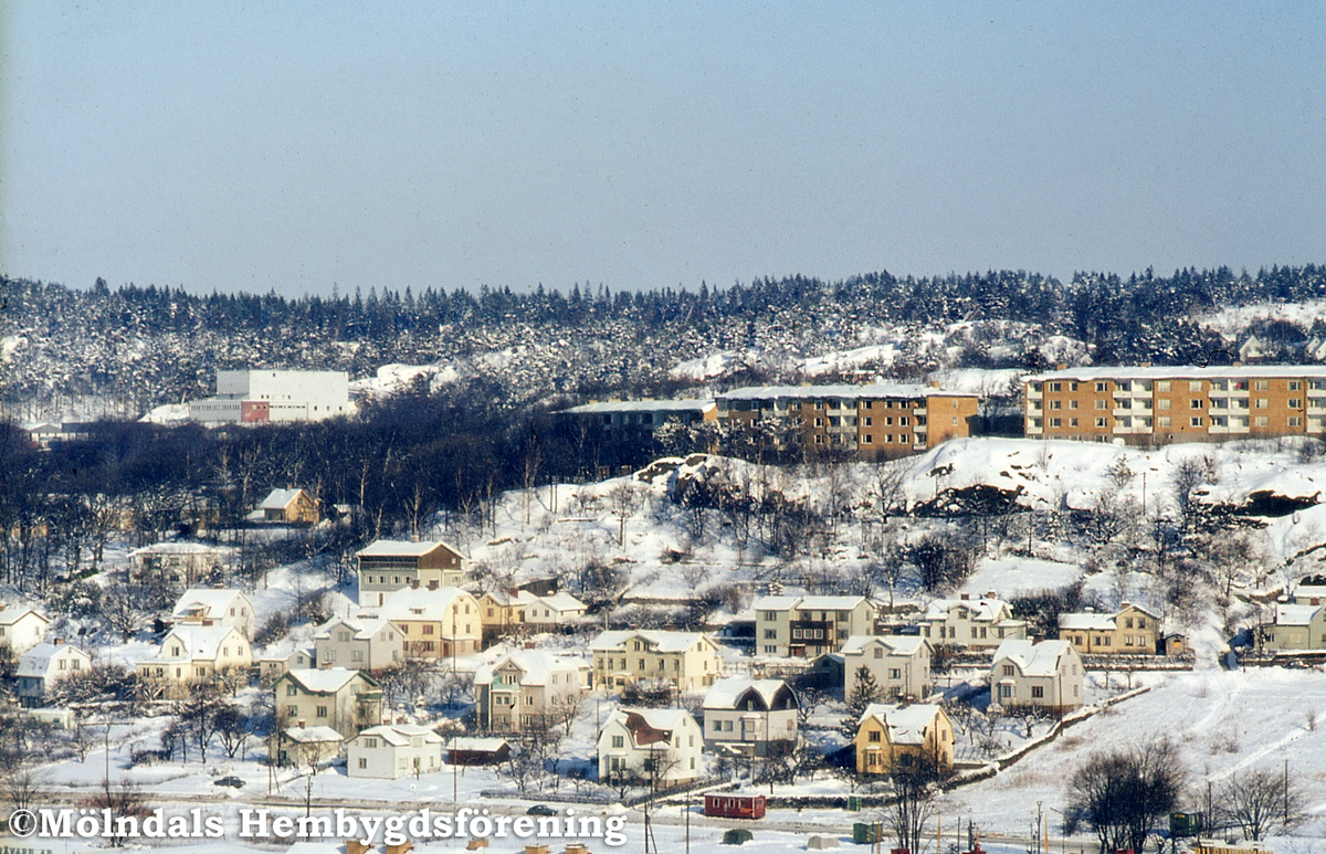 Vy mot bostadsbebyggelse i del av Trädgården och Enerbacken i Mölndal, vintern 1970.