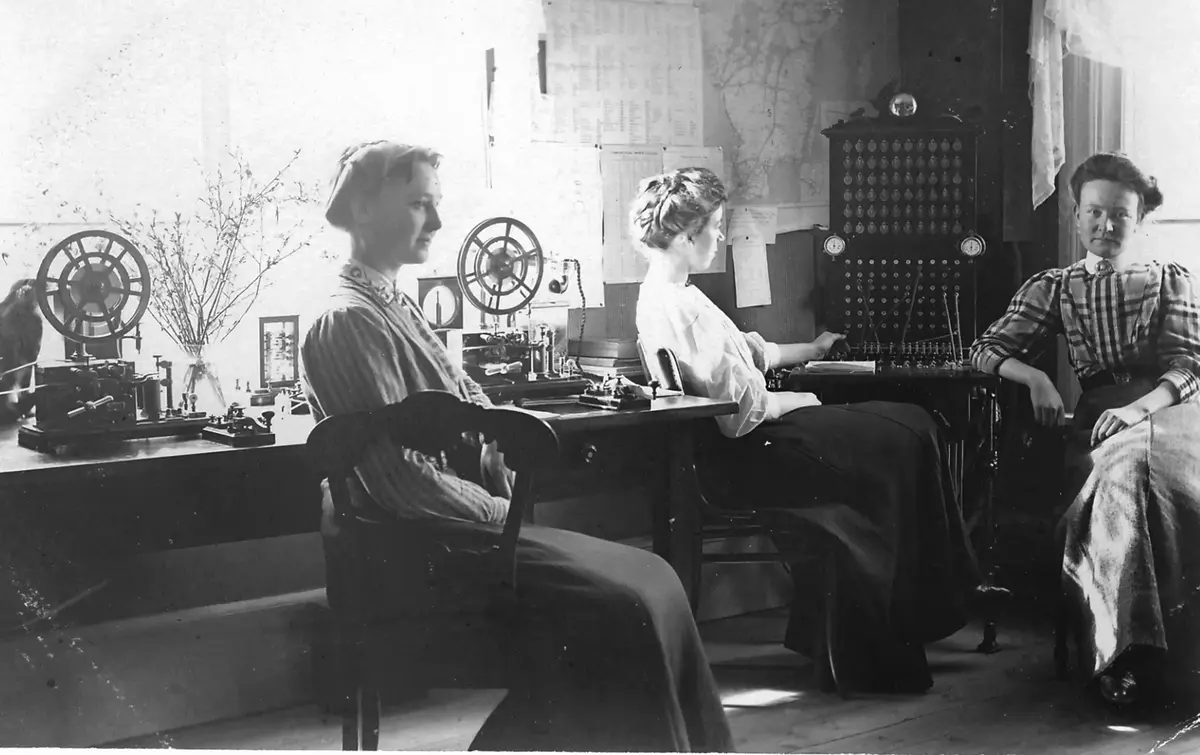 År 1890 installerades en telefonväxel ansluten till Allmänna Telefonaktiebolaget, i september 1899 byggde även Rikstelefon en växel i Gamla Folkskolan vid kyrkan.
År 1904 anställdes Selma Lindersson  Pettersson  som föreståndare för Turinge telefon- och telegrafstation, samma år hade antalet abonnenter ökat till 18 i allmänna telefonbolaget och 3 i rikstelefons nät. Från 1918 övertog Kungliga Telegrafverket Allmänna Telefonbolagets växel  i Turinge med 23 abonnenter. 

Bilden visar interiören från Turinges telegraf- och telefonstation och är från tidigt 1920-tal. Selma Lindersson sitter vänd mot fotografen, sällskapet är troligen telefonisten Elsa Johansson och telefonbiträdet Margit Lindersson, brorsdotter till Selma. Den tekniska utrustningen är två telegrafapparater med pappersband  för att ta emot morsemeddelanden samt två telegrafinycklar för sändning. I bildens mitt syns ett växelbord med kapacitet för 60 linjer, samt två ur för mätning av samtalstid. Växeln kunde hantera 10 samtidiga samtal. 

Växeln flyttades 1931 till gården Långdal cirka 500 meter söder om kyrkan. Den manuella betjäningen upphörde 1948. Bilden, samt en längre artikel är publicerad i Torshammaren årgång 2020, "När telefonen kom till Turinge"