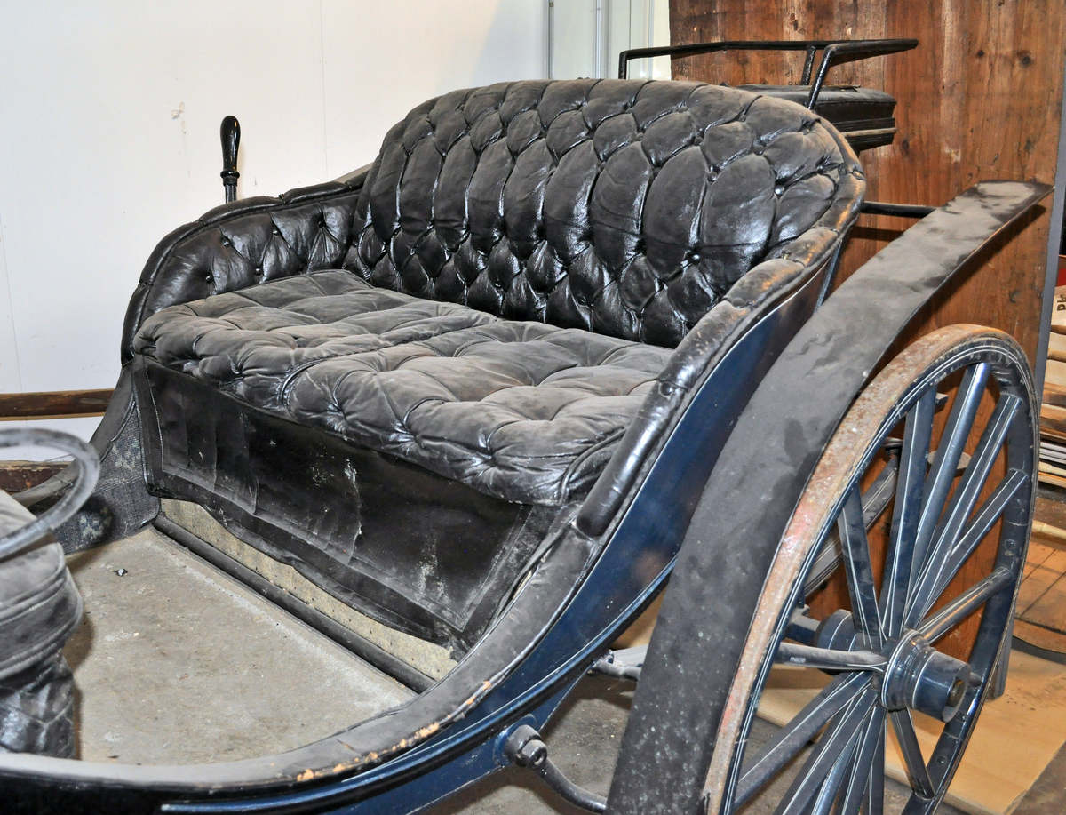 Fra protokollen: Trille, for en hest. Plass til 4 personer + kusk bak. Skinntrekk sete. Vogna er utstyrt med brems og har jerngjorder på hjula. Blålakkert med kvite render. Phaeton-trille.