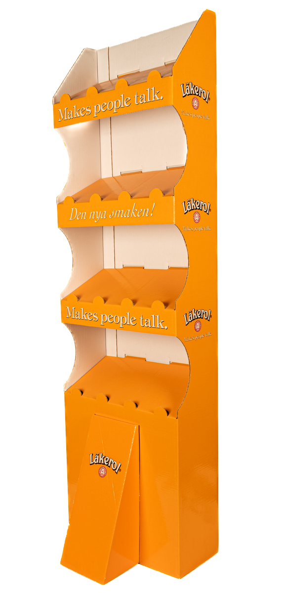 Reklamställ i papp, orange och vitt. Fyra fack för reklamartiklar. Tryckt text: Läkerol Make people talk.