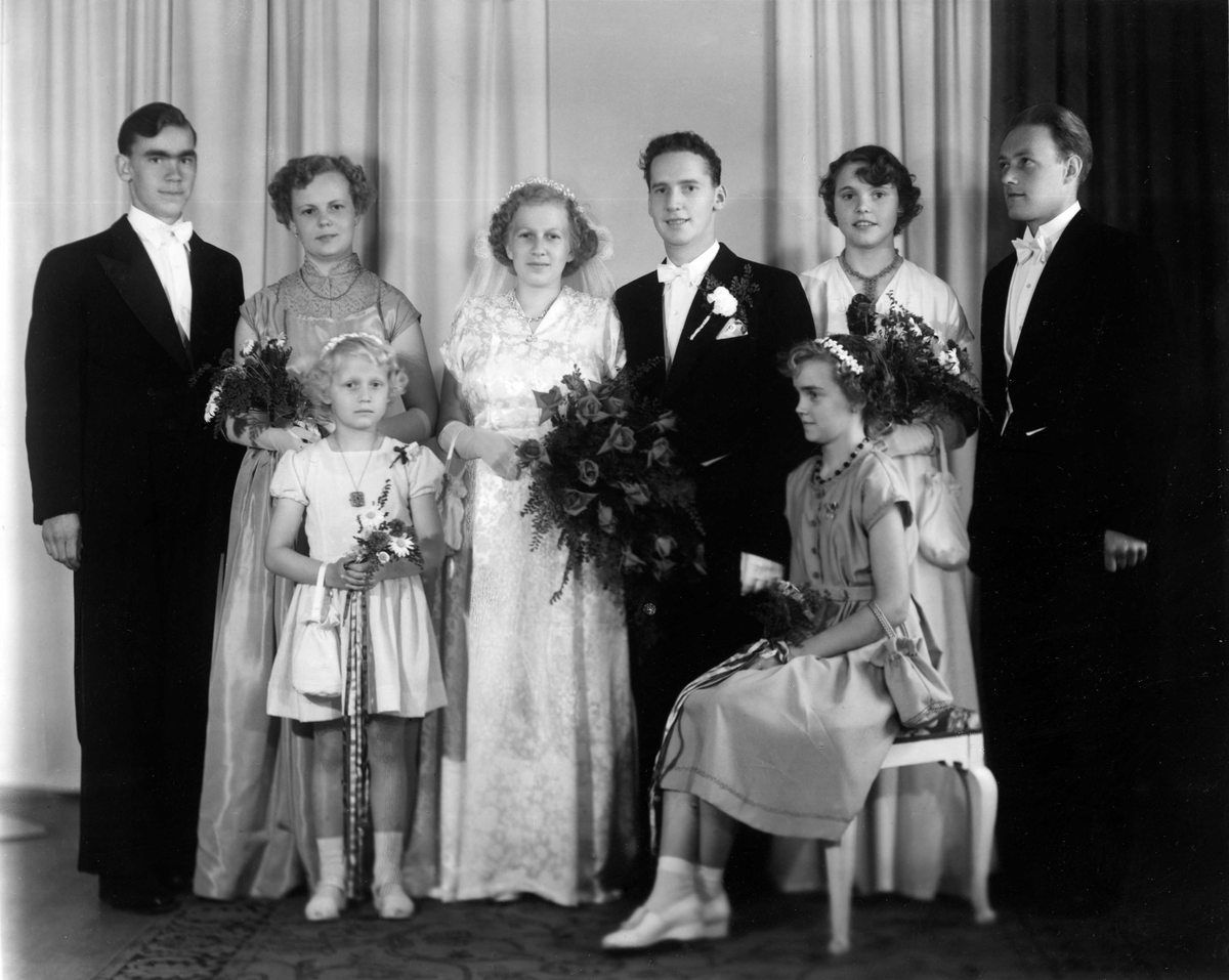 Brudparet Gullvi, född 1932, och Larry Carlsson, född 1929.
Gifte sig i Asmundtorps kyrka i juni 1953.
Längst till vänster Larrys bror Bertil, född 1935, och Larrys kusin Majvi Jönsson, född 1933.
Från höger Larrys kompis och hans syster Bodil, född 1937.
Stående brudnäbben Agneta född 1946, Gullvis syster, sittandes Hjördis Carlsson, född 1941.