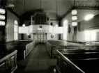 Interiör mot orgelläktaren i Hälleberga kyrka innan branden 1976.