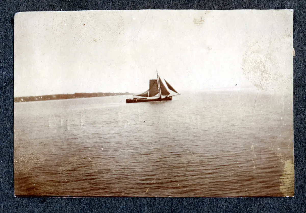 a) Vy över järnvägspår, dansk(?) bondgård och öppen mark

b) Från järnvägsvagnen: hus, ledningar och träd

c) Segelskuta i sund

d) Vy över kanal?

e) Skuldra, del av hatts baksida. Öppet vatten med segelbåt

f) Väg i bokskog

g) Sex unga män i hattar och rockar poserar på däck

h) Från Järnvägsvagnen: alléträd, ledningar och skjul