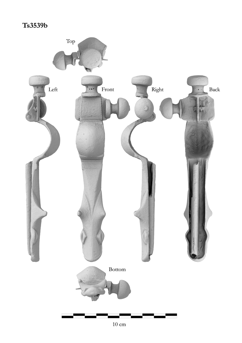 Korsformet spenne av samme hovedform, men på et noe tidligere utviklingstrinn. Dyrehodet er nærmest som l.c. fig. 39, mens overplaten og nåleholderen nærmest er lik l.c. fig. 40. Midtknoppen som er støpt i ett med spennen er nesten flat oppå. En halvkuleformet sideknopp foreligger løs. Lengde 16,2 cm.