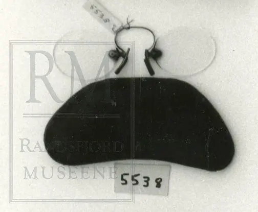 Ingen innfatning- bare metal nese-binder mellom glass. Lorginet. Futteral har formen av loginet, foret innvendig. Er av metall. Festet er knust. Ingen bevis at futteral tilhører til disse brillene. 