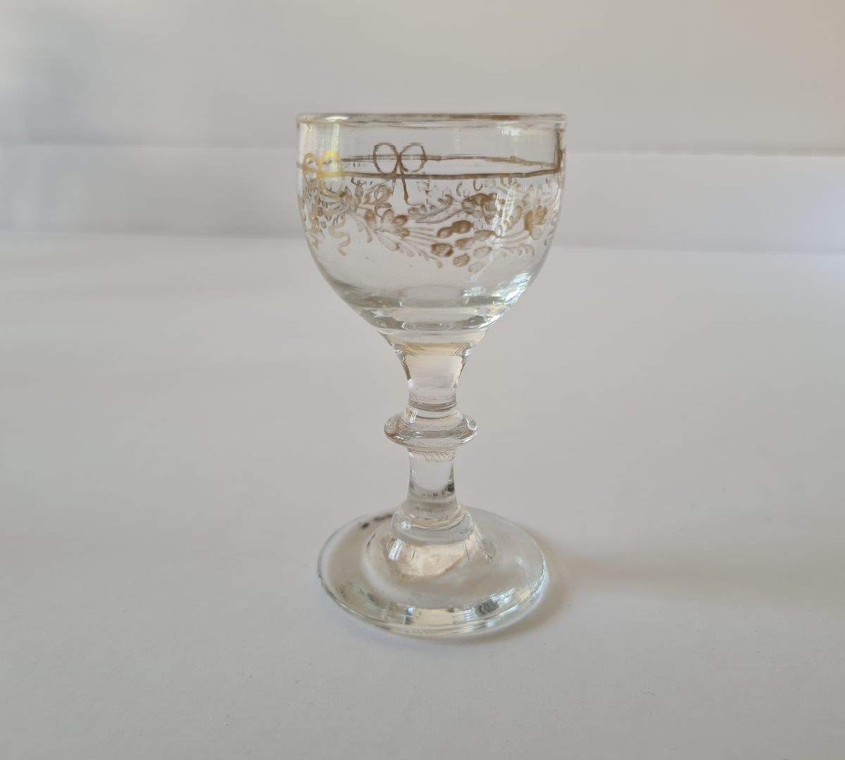 Stettglass av glass. Forgylt dekor på korpus.
