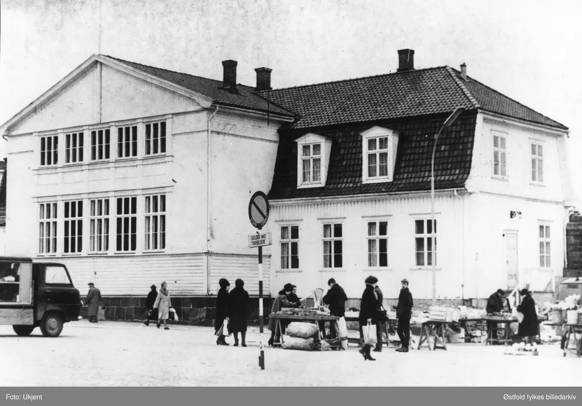 Torghandel på Sarpsborg torg. Domhuset (rettssal) før riving 1967.  Senere ble Sagahuset oppført på tomta.
Skilt med tekst: Stopp forbudt. Gjelder ikke torgselgere.