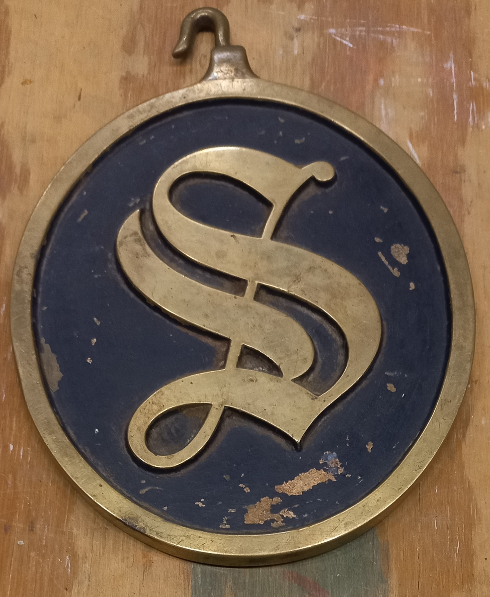 Vaktbricka med upphängningshake, vridbar. B å ena och S å andra sidan.

1) Blå botten, i övrigt blank. Tillhört 3 kl. pb. Ulf.
2) Blå botten, i övrigt blank, Tillhört  3 kl. pb. Folke.
3) S å grön, B å röd botten. I övrigt blank.
4) och
5) Mörkblå botten. I övrigt blank.




1) Tillh. 3:c kl. pb. Ulf.
2) Tillh. ?      ?    ?     Folke.Föremålets form: oval