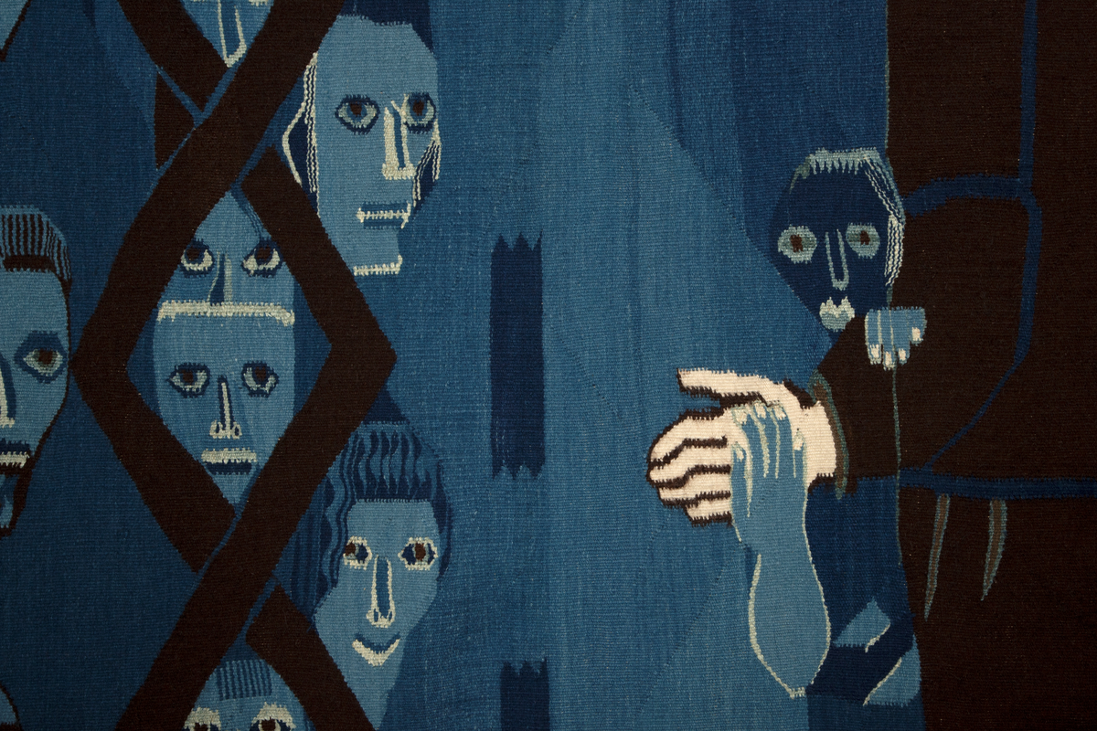 Figurativt og ornamentalt motiv vevd i hovedsakelig blått, mørkbrunt og hvitt (det brune og hvite er ufarget saueull, mens det blå er en rekke nyanser av potteblått, altså farget med planten indigo). Motivet er holdt i flaten med kun overlapping som uttrykk for romlighet. En stor, dresskledd mannsfigur er plassert i høyre del, og dominerer motivet. Han fyller nesten hele høyden, og er vendt mot (vår) venstre i trekvart profil; ansiktet er detaljert og svært lyst i kontrast til omgivelsene. Med sin venstre hånd holder han fast i en trekantform der kunstnerens signatur, verkets tittel og årstall, samt ordet 'NEI' to ganger er vevd inn. I sin høyre hånd holder han hånden til en liten, barbent, blå figur som opptrer nærmest kamuflert i bakgrunnen; denne støtter også sin andre hånd på mannsfigurens underarm. I motivets venstre del sees atten hoder ordnet i tre vertikale kolonner; den midre kolonnen er plassert bak eller inne i en geometrisk rankebord, mens den øverste og nederste figuren i høyre kolonne holder et langt sverd mellom seg. På sverdets håndtak står det 'NATO'. Bakgrunnen for figurene er blå, og i motivets høyre del, sammen med teksttrekanten, er det vevd en rekke asymmetriske ornamenter, også i blåtoner.