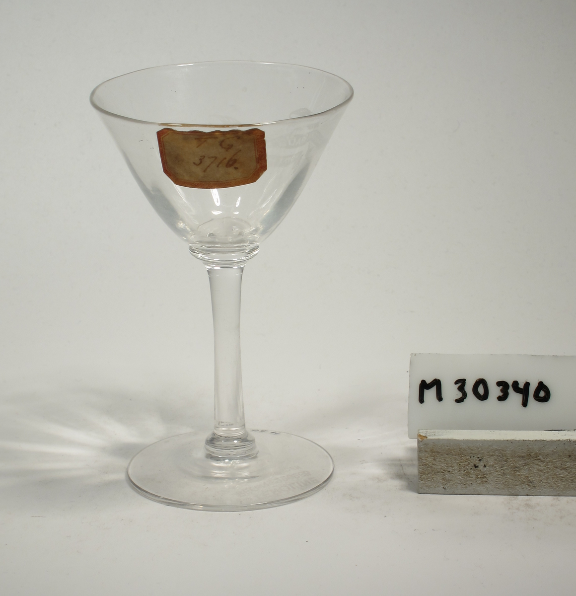 Konande kupa med tunt glas och optik. Etsad text i bandslinga: "GEORGE BRADSHAW NORTHHAMPTON"