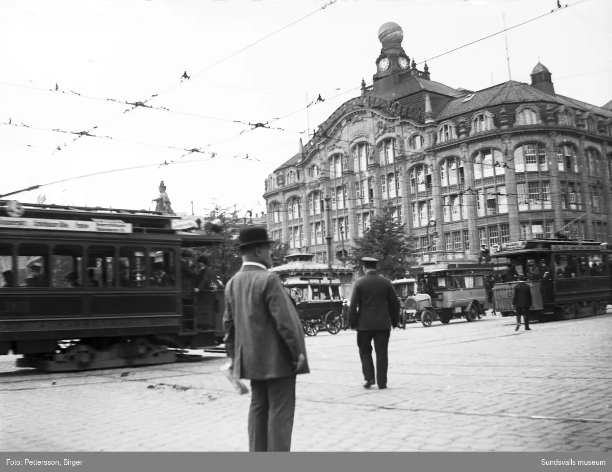 Spårvagnar, bilar och människor på Alexanderplatz i Berlin. Den ståtliga byggnaden är varuhuset Tietz, senare Hertie.