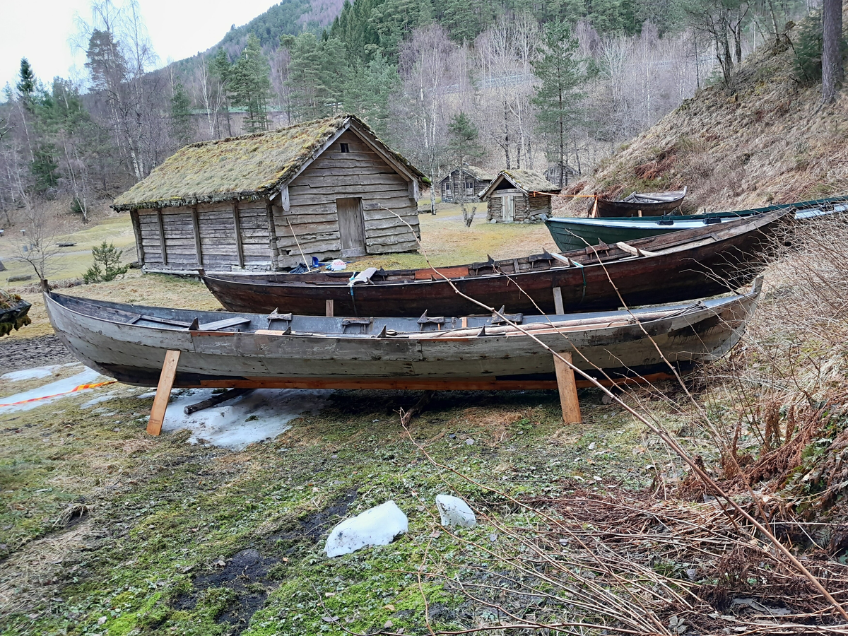 Båt. Kyrkjebåt. Klinkbygd trebåt. 4 omfar. Firrøing. For årar og segl. Kvitmåla utvendig, invendig måla mørk gråleg. Restar av raudmåla, tynn stripe langs ripa oppå og på utsida. Delar av m.a. kjøl og botnabord utskifta i nyare tid (umåla).