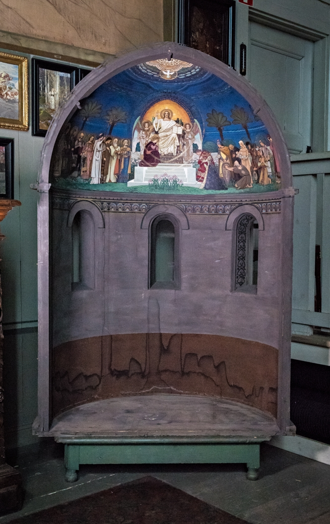 Modell till Lunds domkyrkas korabsid. I den halvsfäriska kupolen avbildas Jesus sittande i centrum på en upphöjd tron med höjd vänsterarm, Majestas Domini. I den högra hand håller han en bok. På var sida om honom en ängel. Över Jesus en guldfärgad mandorla. Framför tronen liljor. Till vänster om tronen stående figurer med glorior och text:Mattheus, Markus, Lukas, Johannes, Ansgarius, Laurentius, Paulus och Petrus. Till höger delvis stående, delvis knäböjande fgurer, t.ex. biskop med kräkla, kvinna med lindebarn och en fattig man. Mörkblå bakgrund med palmer. Ovanför Jesus i kupolens mitt en vit duva, troligen Andens duva med korsgloria, och Jahve på hebreiska. 
Under motivet dekorativt utformade bårder. Nedanför motivet tre utsparade fönster. Väggen målad i grått och brunt.