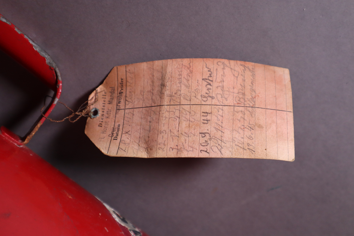 Brannslukningsapparat med veggfeste. Håndtak nesten helt oppe på ene siden.