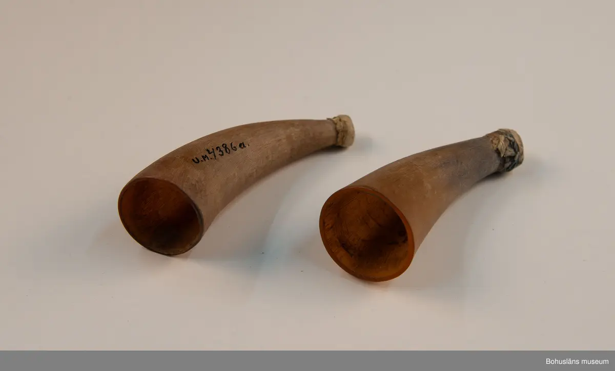 Ur handskrivna katalogen 1957-1958:
Två horn för koppning
a) L. c:a 9,5 cm; av kalv, spetsen avskuren och överbunden m. tunnt skinn, sprucket; f.ö. helt. b) på undersid. ett lock som skyddar ett spegelglas i 2 delar. Defekt.

Lappkatalog: 94