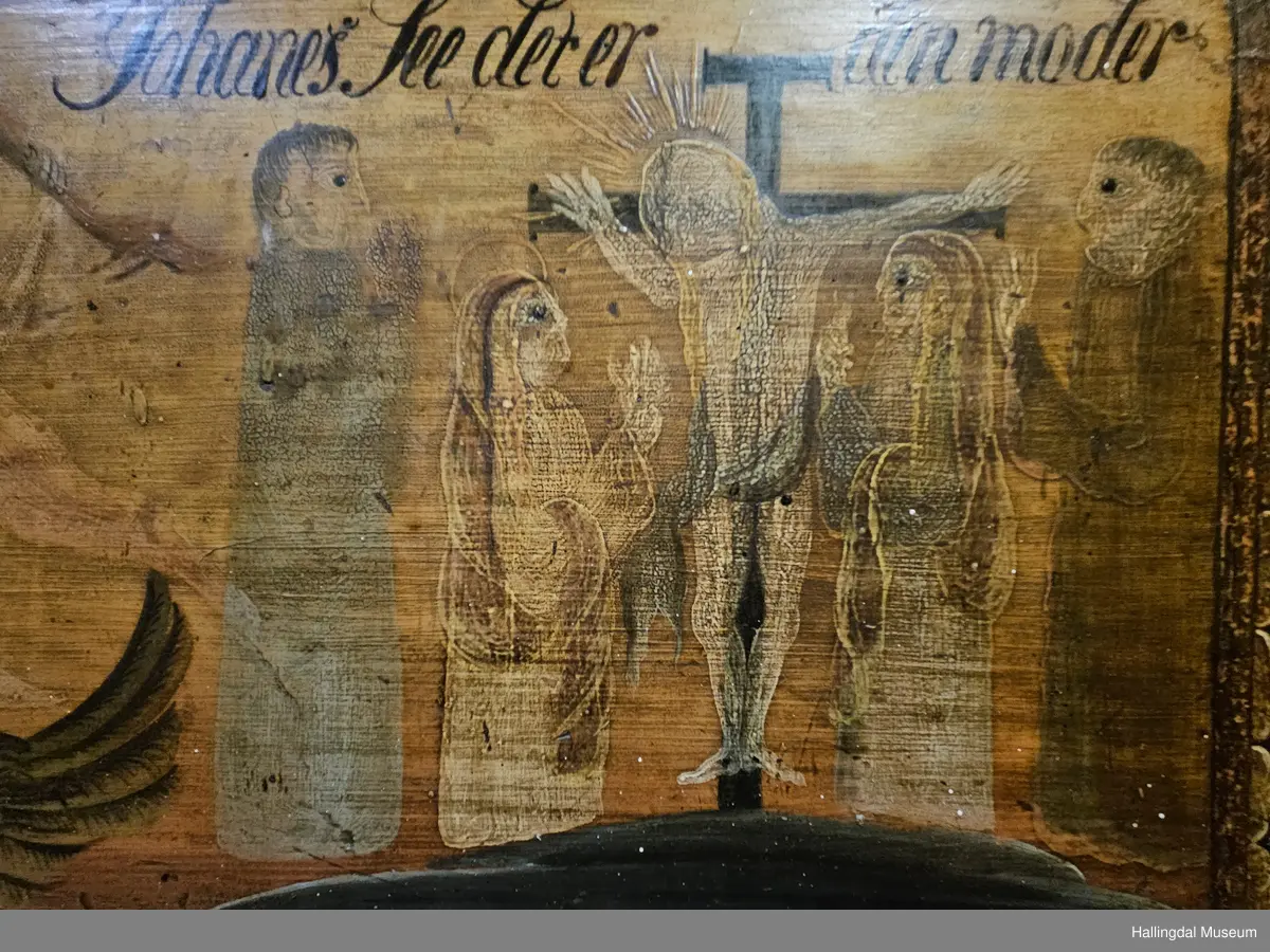 Skatoll med 3 like store skuffer pluss en mindre skuff over disse. På sidene av den øverste skuffen er det støtter som kan dras ut til platen som kan legges ned.  Platen er malt med 3 ulike motiv: Til venstre Maria og Josef med Jesusbarnet og 2 esler i stallen. I midten: En engel med rosa sjal som holder over hodet et brunt klede. Engelen står oppå en kule over englevinger. Til høyre: Jesus på korset med 2 damer og 2 menn.  
De 3 nederste skuffene er malt, 4 rosebuketter på hver skuff. Understellet er utskjært, ranke. 
Bak platen er det 6 små skuffer på hver side av et åpent rom.  Oppå skuffene og platen er det et buet skap med 2 hyller og øverst hylle for tallerker eller skjeer. Dørene har utskjærte speil som er rosemalt. Dørene er gråmalt på baksiden.
Bunnfargen på skatollet er mørk grønt og noe er brunrødt.
