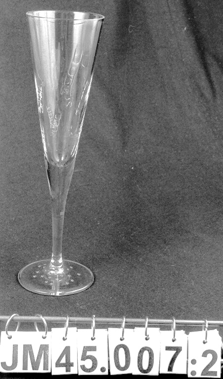 Flaska av grönt glas för mousserande druvdryck, Blanc de Blancs, av färskpressade gröna druvor. Blå och guldfärgad etikett på framsidan med texten: "ÅKESSON MILLENNIUM SÖT MOUSSERANDE DRUVDRYCK". Etikett på baksidan med information om drycken samt på flaskhalsen med namnet på drycken. Flaska tom.