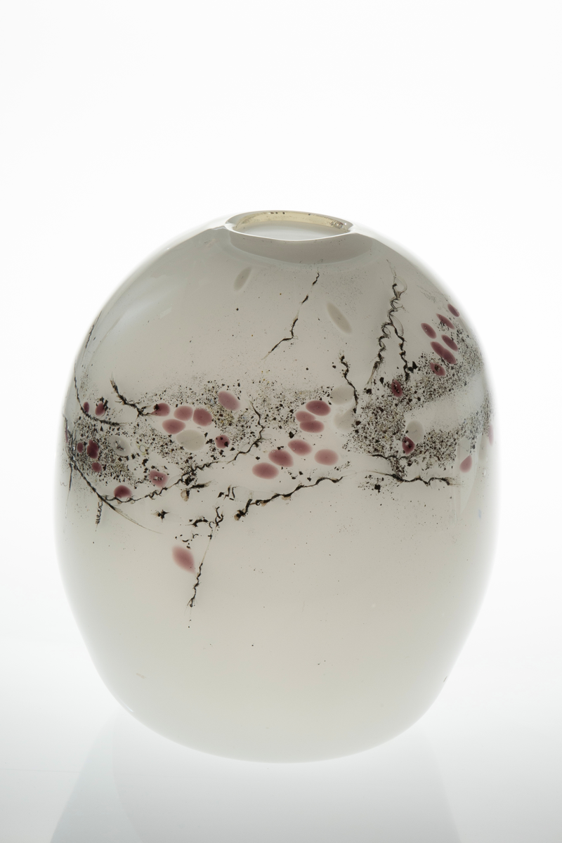 Ovalformet vase i underfangsglass, og liten sirkelrund åpning. Det innerste sjiktet er i melkehvitt opakt glass, mens det ytre er i klart glass. Vasens øvre del er dekorert med glassfibertråd og jernfilspon som danner et asymmetrisk mønster av rødfiolette pletter og organiske sorte striper. Dette skaper assosiasjoner til kirsebærtrær, derav vasens navn. Puntemerke under vasens bunn.