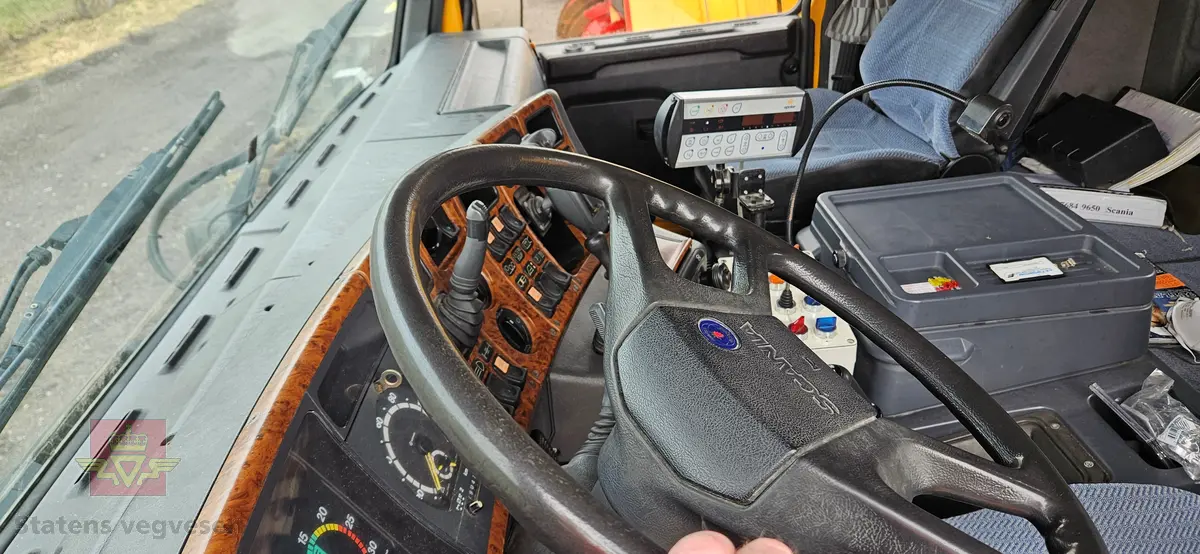 Scania R143HL tre-akslet lastebil, bygd med utstyr for salting og brøyting. Motoren er en dieseledrevet forbrenningsmotor med et slagvolum på 14000 cm3 og en ytelse på 309 KW (420 HK). Bilen er i hovedsak gul. Dekkdimensjon oppgitt i motorvognregisteret på aksel 1 er 315/80R X 22,5. og aksel 2 er 295/80R X 22,5 X 2 X 2. Antall seter er to. Merking fra bruker og produsenter.