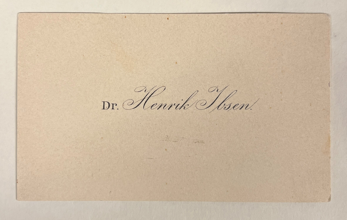 Oppstillingsliste: " Visittkort  / Kartong med trykk / Trykk: Dr. Henrik Ibsen."
To identiske visittkort; ett ubrukt, ett gulnet/brukt
