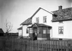 Man på trappan framför bostadshus, ca 1900.