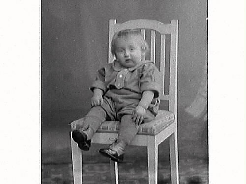 Liten pojke på två bilder i olika kläder med en stol. Gustaf Antonsson Södergatan 16, Varberg beställde bilderna och är troligen barnets far.