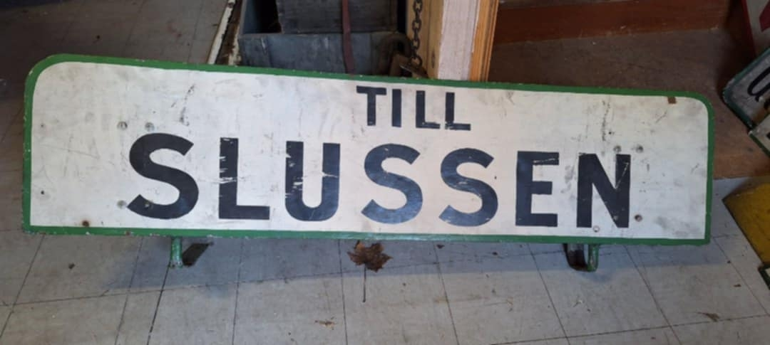 Plåtskylt för färjetrafiken till Slussen. Har suttit på ett båttak.