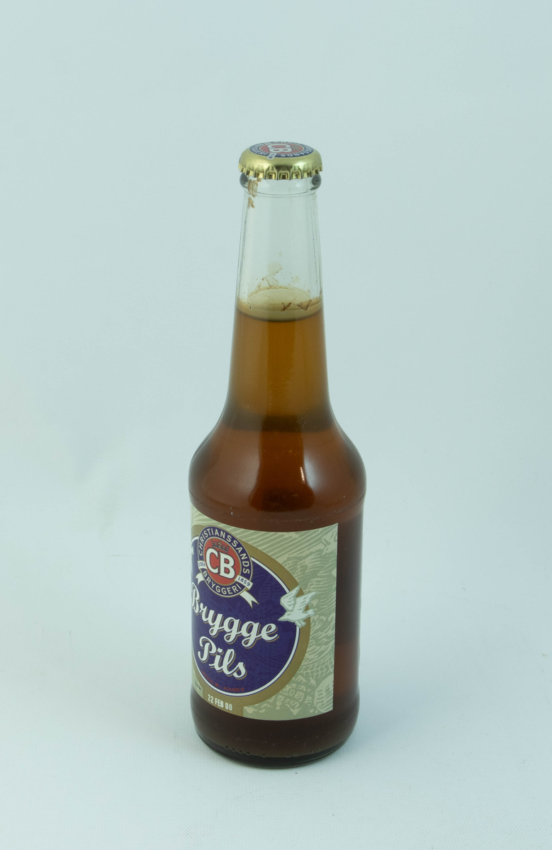 Klar glassflaske med flerfarget etikett