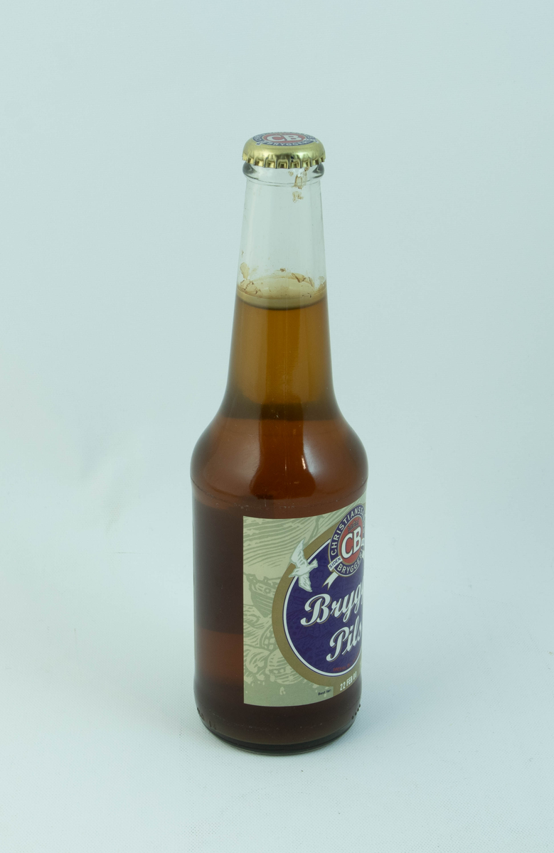 Klar glassflaske med flerfarget etikett