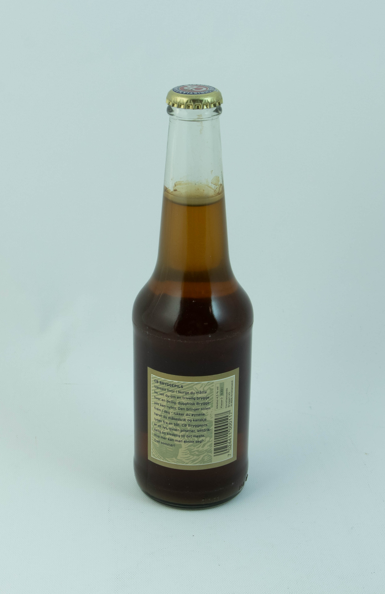 Klar glassflaske med flerfarget etikett