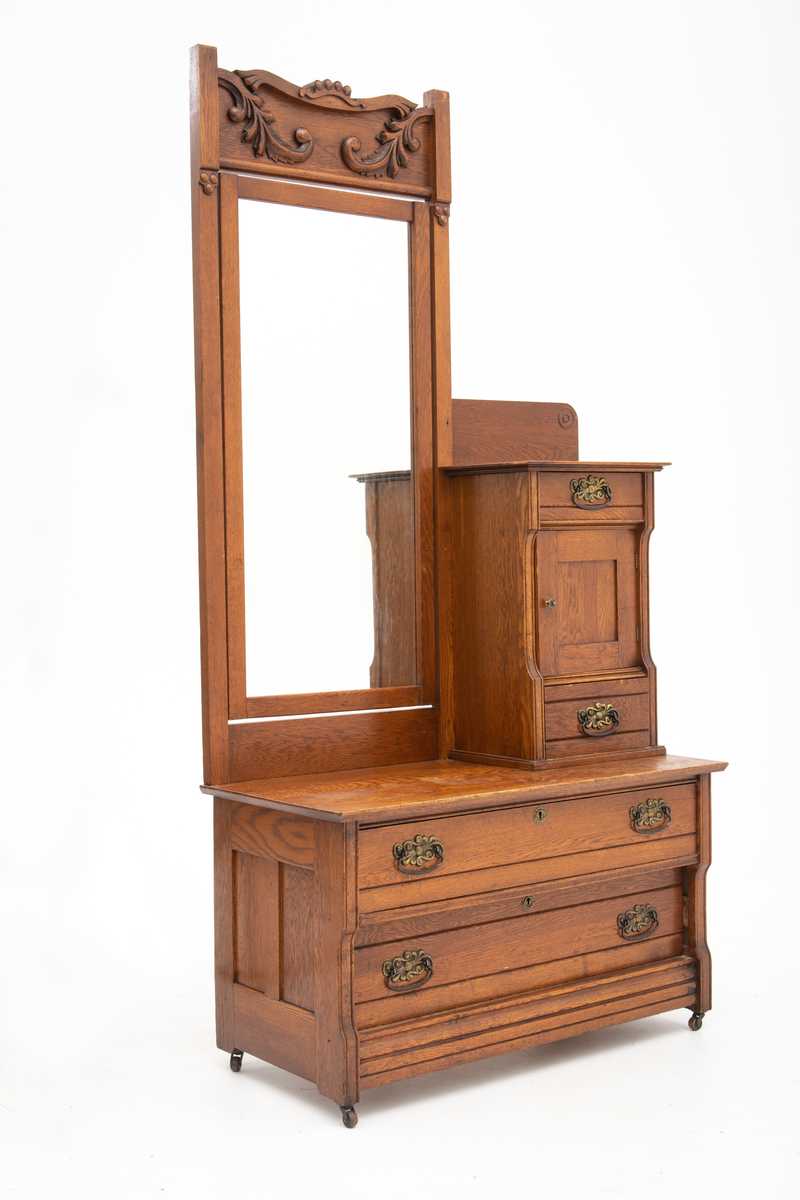 Speil tilhørende entremøbel. Rektangulært vippespeil montert i ramme med utskjæringer.. Slipt speilglass.