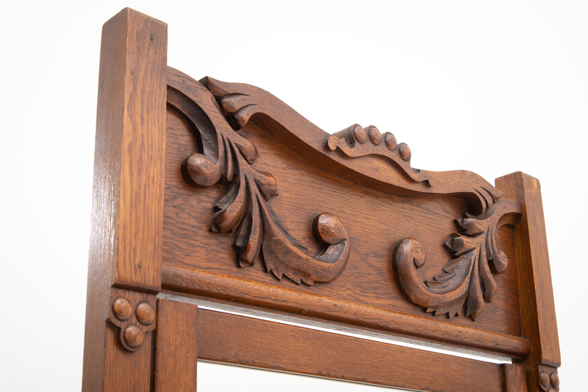 Speil tilhørende entremøbel. Rektangulært vippespeil montert i ramme med utskjæringer.. Slipt speilglass.